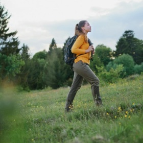A beautiful community at the heart of all your passions a woman hiking in a field